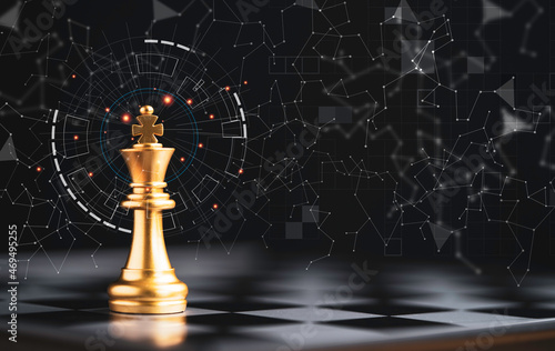 Фотография Golden king chess standing alone on chess board and dark background with connection line for strategy idea and futuristic concept