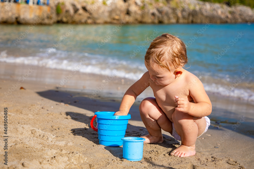 Little girl playing with sand on beach. Enjoying a lovely vacation. Little girl playing with sand on beach. Enjoying a lovely vacation.
