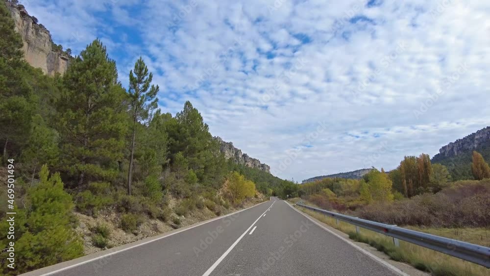 Driving along the karstic cliffs in large lagoon of Tobar at Hoz de Beteta, Cuenca, Castilla la Mancha, Spain, Landscapes of the mountain range of Cuenca Driving along the karstic cliffs in large lagoon of Tobar at Hoz de Beteta, Cuenca, Castilla la Mancha, Spain, Landscapes of the mountain range of Cuenca
