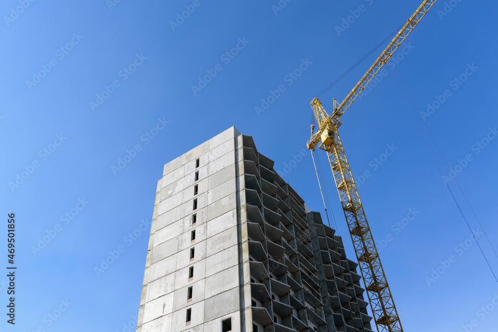 Construction of a multi-storey building. High-rise construction crane. Blue sky. Construction of a multi-storey building. High-rise construction crane. Blue sky.