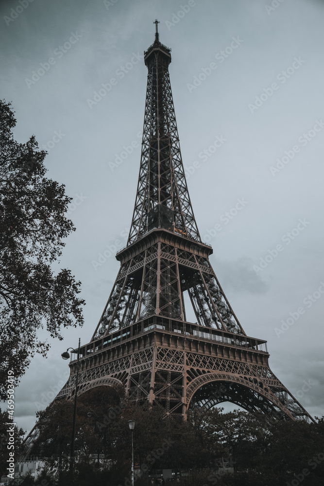 Autumn, cloudy Eiffel Tower in Paris, in the evening without lighting