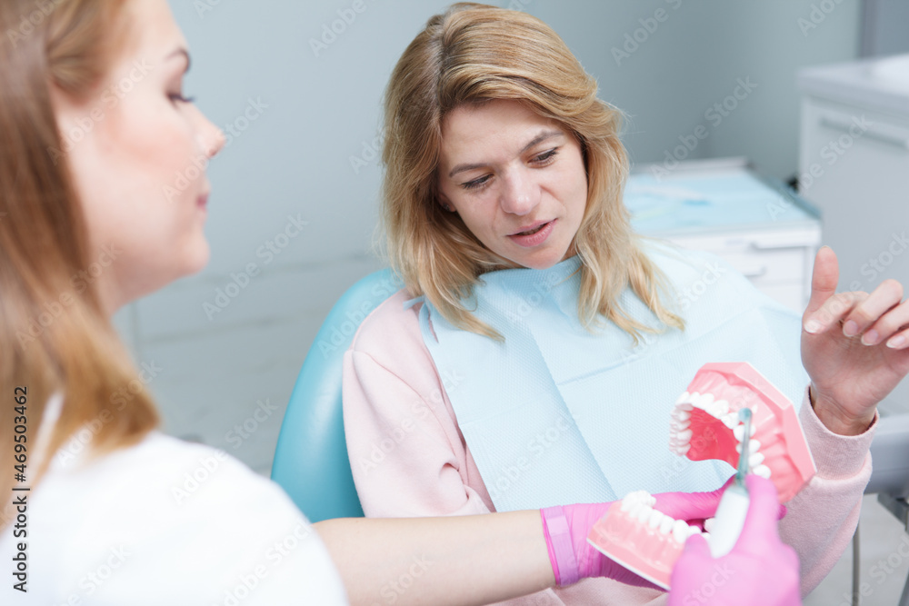 Fototapeta premium Mature woman talking to her female dentist
