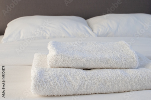 White clean towels stacked on the hotel bed. High quality photo © ercan senkaya