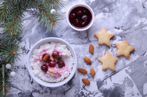 Christmas rice pudding with almonds and cherries on a light background. Risalamande