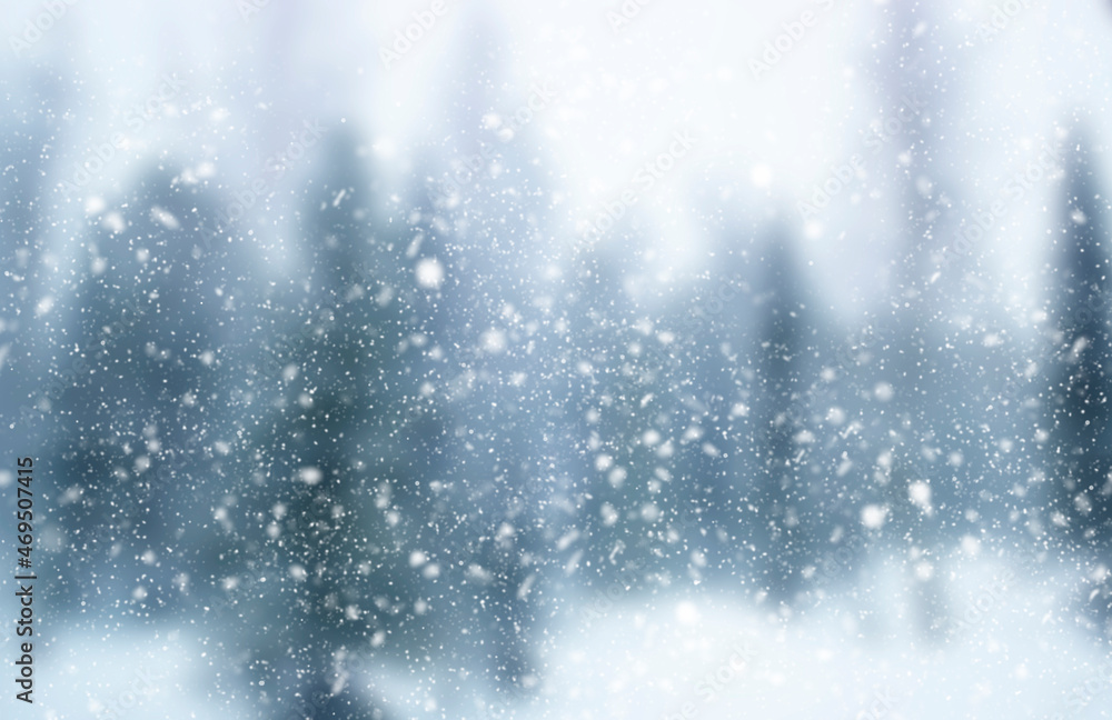 Blurred winter background. Falling snow on the background of an out-of-focus forest Blurred winter background. Falling snow on the background of an out-of-focus forest