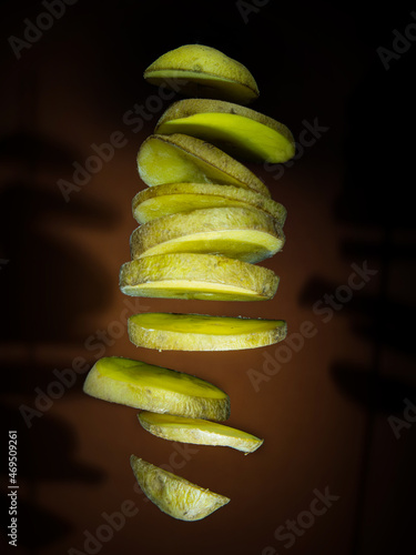 Potato slices floating on dark background
