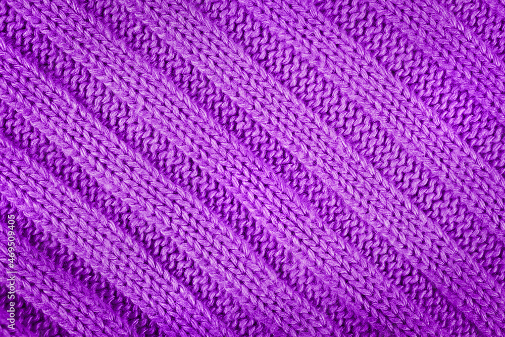 Purple knitted textured background with a pattern closeup