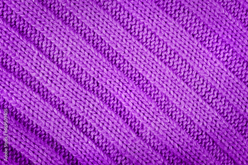 Purple knitted textured background with a pattern closeup © Maksim