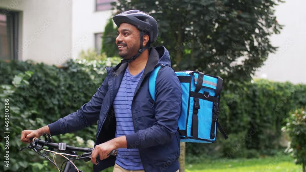 food shipping, profession and people concept - happy smiling indian delivery man with thermal insulated bag and bicycle on city street food shipping, profession and people concept - happy smiling indian delivery man with thermal insulated bag and bicycle on city street
