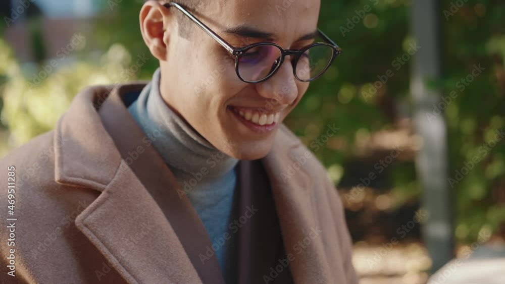 Close-up view of Arabian man in eyeglasses working in park Close-up view of Arabian man in eyeglasses working in park