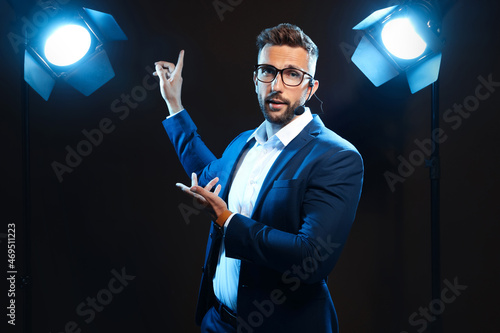 Motivational speaker with headset performing on stage