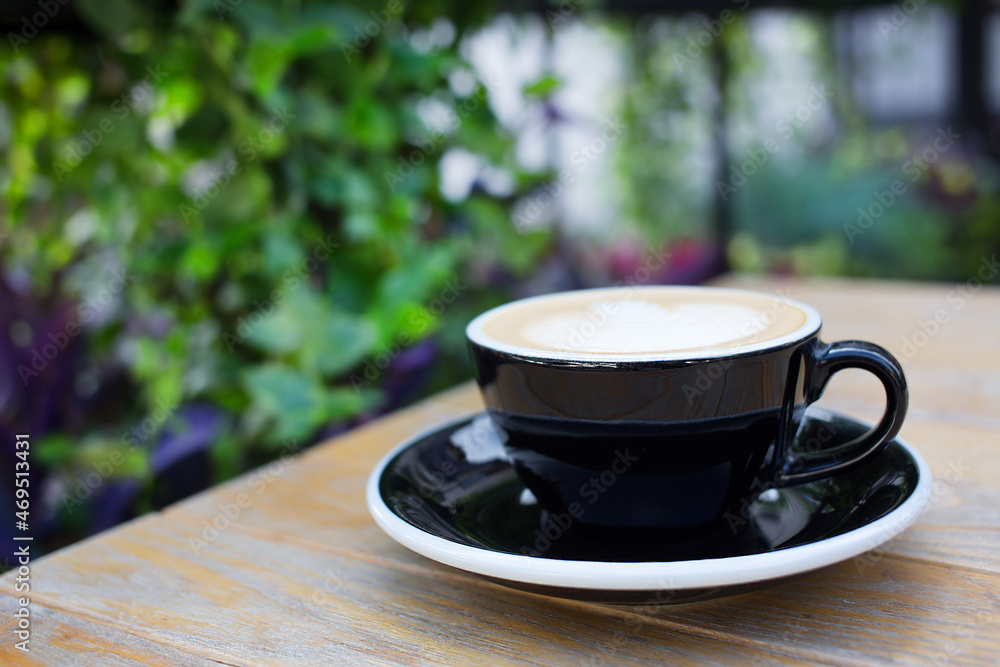 Cup of aromatic coffee with foam on a wooden table in a cafe. Cup of aromatic coffee with foam on a wooden table in a cafe.