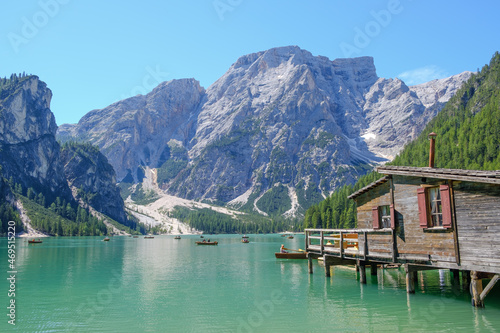 Lake Braies (also known as Pragser Wildsee or Lago di Braies) in Dolomites Mountains, Sudtirol, Italy. Romantic place with typical wooden boats on the alpine lake. Hiking travel and adventure.