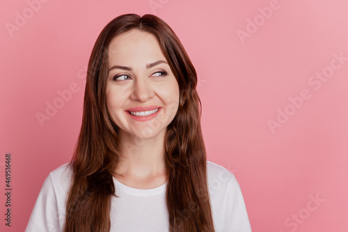 Portrait of funny dreamy inspired girl shiny smile look empty space on pink background