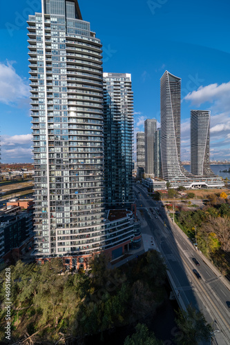 Drone Views of condos and Humber bay shores with  brown trees tops Fall colours by Parklawn rd and lakeshore   with blue skies and broken clouds  photo