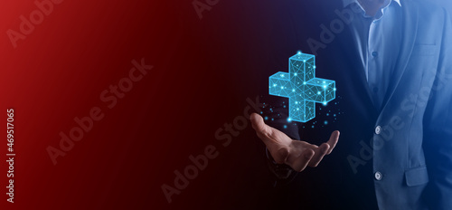 Businessman hand holding 3D plus low polygonal icon.Plus sign virtual means to offer positive thing like benefits, personal development, social network Profit,health insurance, growth concepts.
