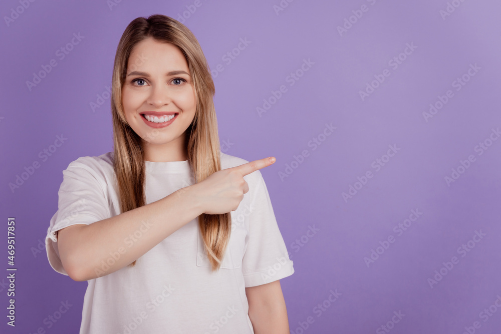 Photo of positive advertiser lady indicate empty space wear casual clothes on violet background Photo of positive advertiser lady indicate empty space wear casual clothes on violet background