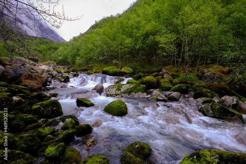 Cold water flows through a brook from the Briksdal glacier inside Jostedalsbreen National Park, Stryn, Vestland, Norway, Scandinavia