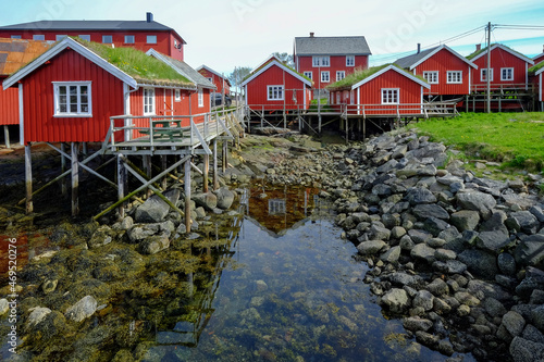 Red buildings grace the shoreline in the cod fishing village of Reine, Lofoten Islands, Nordland, Norway, Scandinavia