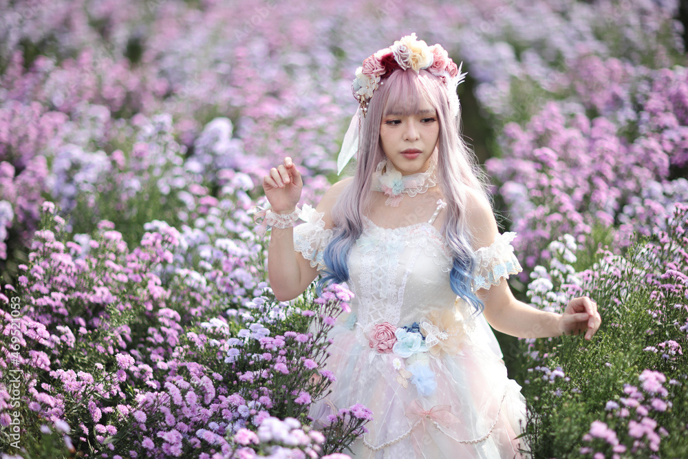 Fototapeta premium Beautiful young woman with white lolita dress with flowers garden Japanese fashion