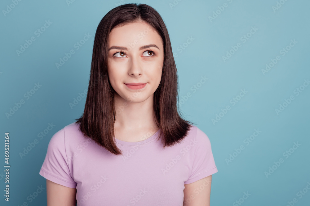 Photo of nice attractive girl happy positive smile wondered idea look empty space isolated over teal color background Photo of nice attractive girl happy positive smile wondered idea look empty space isolated over teal color background