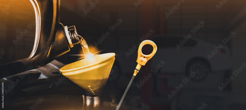 Mechanic pouring motor oil to engine with copy space on black background,Double exposure concept