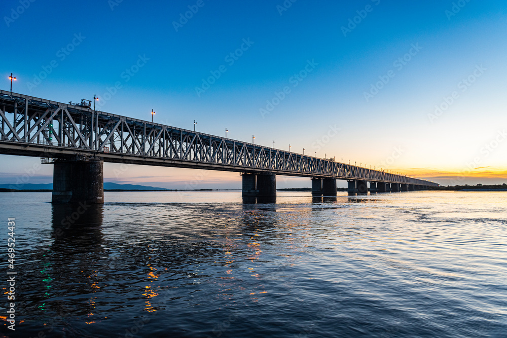 Giant bridge spanning over the Amur River at sunset, Khabarovsk, Khabarovsk Krai Giant bridge spanning over the Amur River at sunset, Khabarovsk, Khabarovsk Krai
