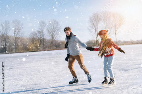 Картината върху платно Loving couple in warm sweaters having fun on ice
