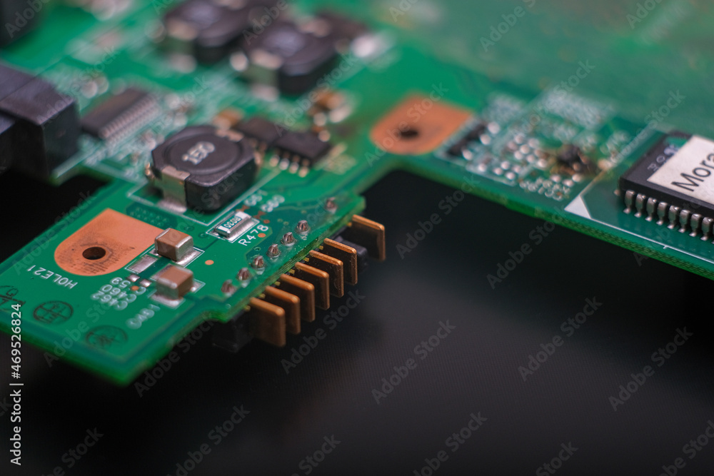 Part of an electronic printed circuit board with many electrical components. Part of an electronic printed circuit board with many electrical components.