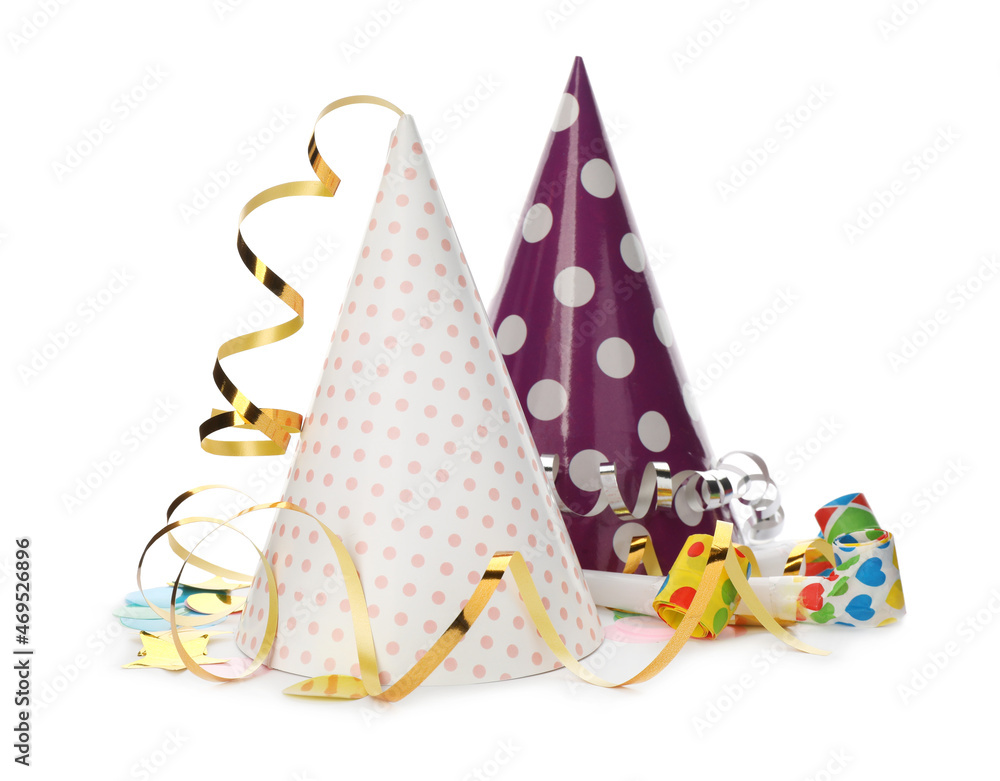Party hats, blowers and confetti streamers on white background