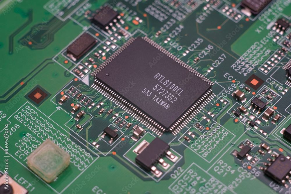 Part of an electronic printed circuit board with many electrical components. Part of an electronic printed circuit board with many electrical components.