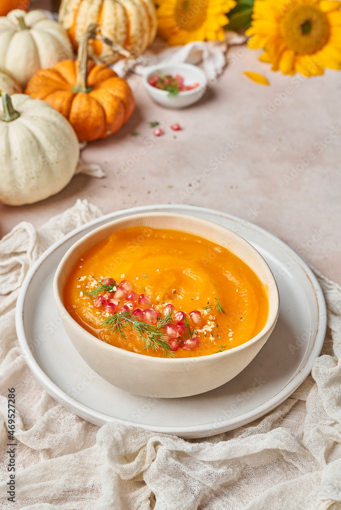 Pumpkin soup near sunflowers in kitchen Pumpkin soup near sunflowers in kitchen