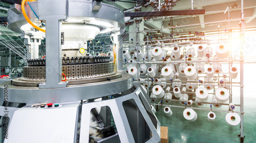 Photography Textile industry - yarn spools on spinning machine in textile factory