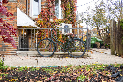 Canvas Print A retro style bicycle sits locked to a railing outside a 1930's building in Toronto's Beaches neighbourhood