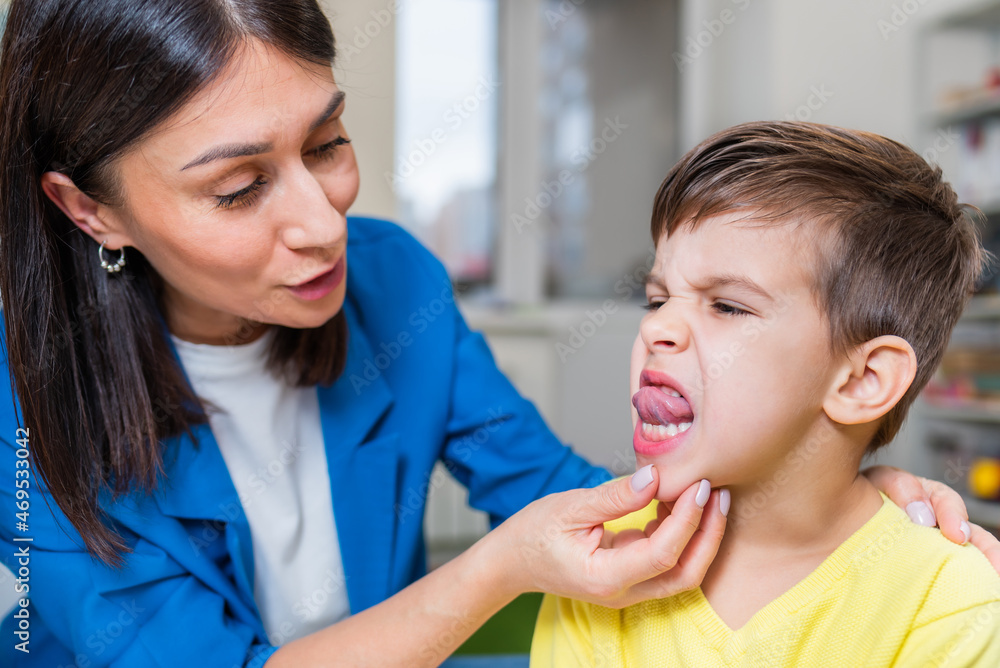 A woman speech therapist deals with the child and teaches him the correct pronunciation and competent speech. A woman speech therapist deals with the child and teaches him the correct pronunciation and competent speech.