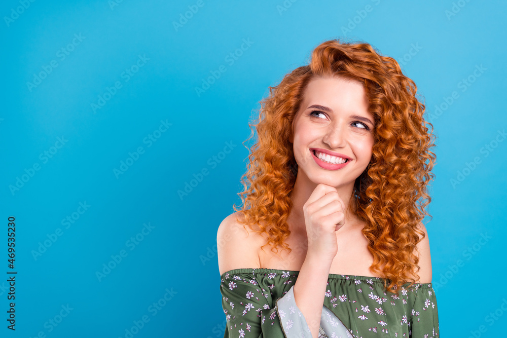 Photo of young girl happy positive smile hand touch chin dreamy guess look empty space isolated over blue color background Photo of young girl happy positive smile hand touch chin dreamy guess look empty space isolated over blue color background