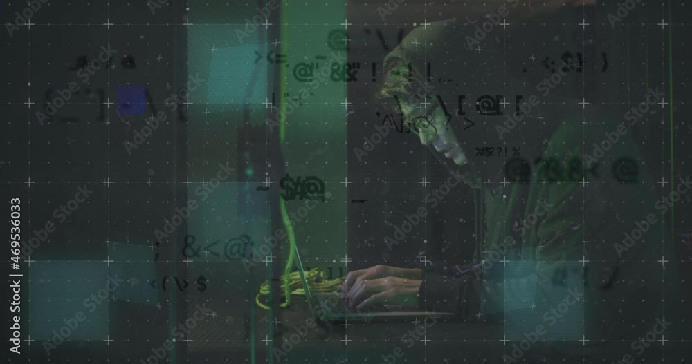 Animation of data over asian male hacker in hoodie using laptop by computer server Animation of data over asian male hacker in hoodie using laptop by computer server