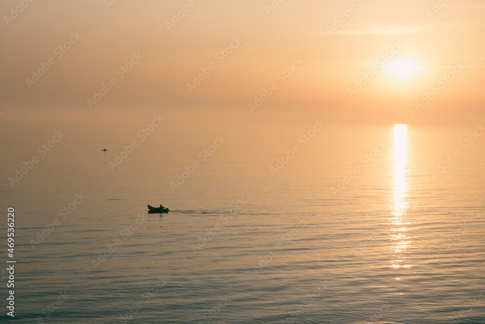 Fototapeta premium Silhouette of kayaks on the sea during sunset
