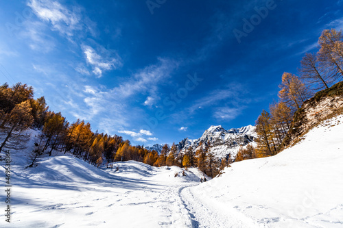 ossola valley with snowy paths and blue sky