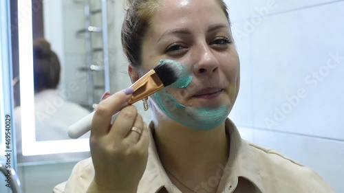 woman applying mask on skin