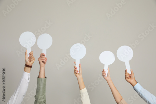 Canvas Print Panel of judges holding blank score signs on beige background, closeup