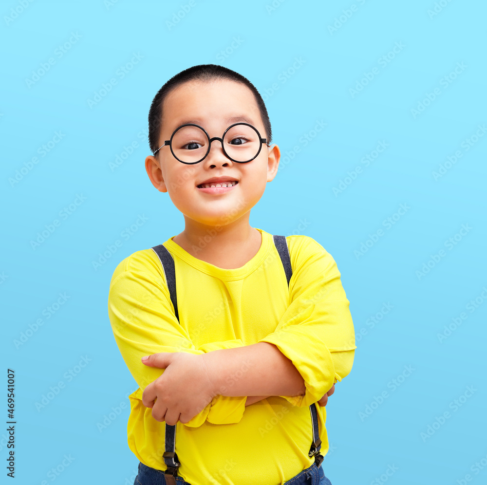 little boy standing with arms crossed and wearing eyeglass. little boy standing with arms crossed and wearing eyeglass.