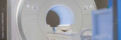 Modern magnetic resonance imaging machine standing in clinic background