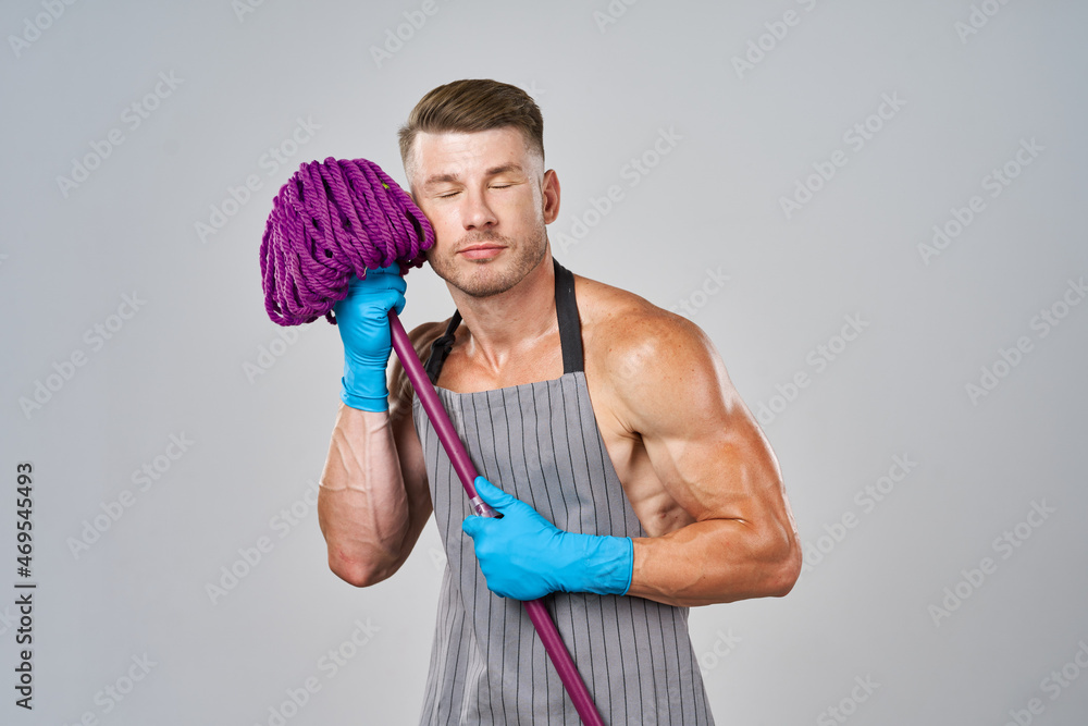 a man with a mop in his hands cleaning service posing a man with a mop in his hands cleaning service posing
