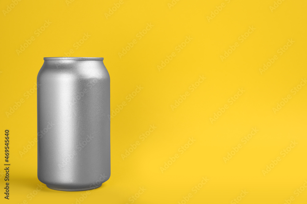 Can of energy drink on yellow background. Space for text Can of energy drink on yellow background. Space for text