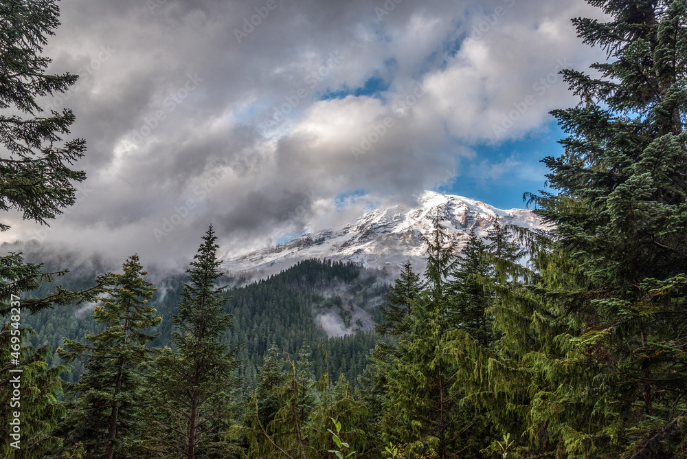 The Mt Rainier hiding behind clouds, seen from the Nisqually river The Mt Rainier hiding behind clouds, seen from the Nisqually river