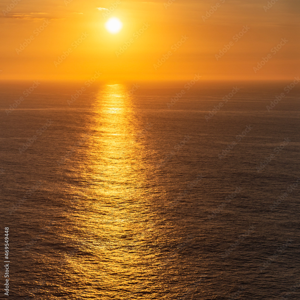 beautiful sunset on the calm sea surface as a natural background