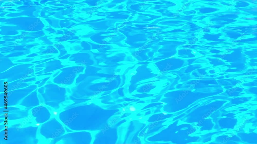 Pure blue water in the swimming pool with light reflections. Slow motion 4K. water surface top view. Pure blue water in the swimming pool with light reflections. Slow motion 4K. water surface top view.