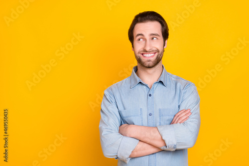 Photo portrait of young business man smiling happy folded hands looking copyspace isolated bright yellow color background © deagreez