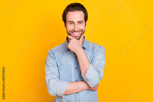 Photo of young handsome man happy positive smile hand touch beard barber shop isolated over yellow color background